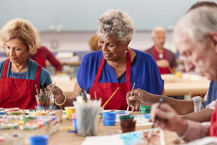 Retired Senior Woman Attending Art Class In Community Centre