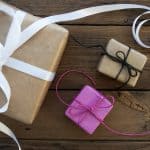 Three Gifts With Ribbons On Wooden Background