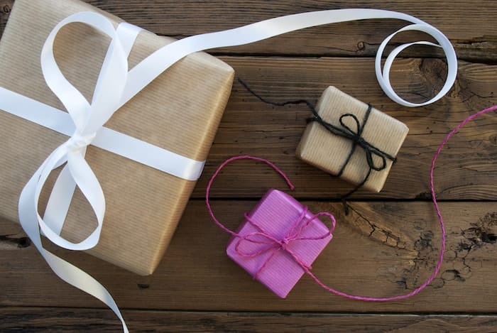 Three Gifts With Ribbons On Wooden Background